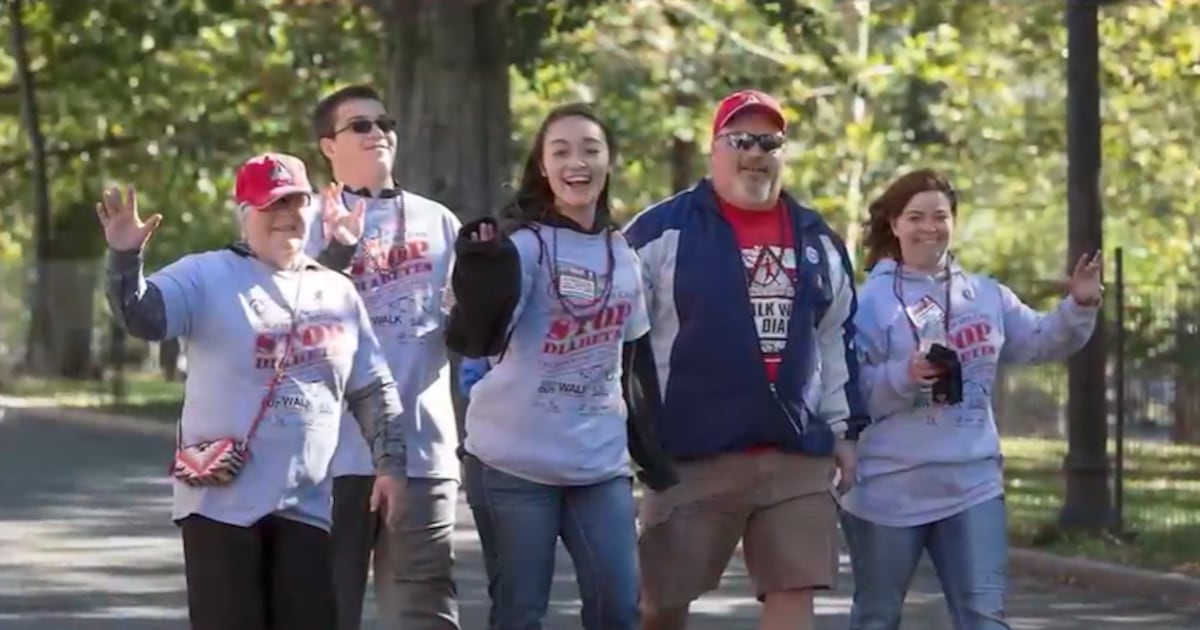 Participants in the American Diabetes Association's Atlanta's Step Out Walk, a fundraising event to support individuals with diabetes and raise awareness about the disease, walking down a tree-lined street