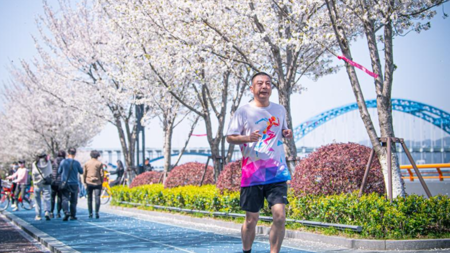 A man running in a park with cherry blossoms, symbolizing the urgent fight against China’s diabetes surge