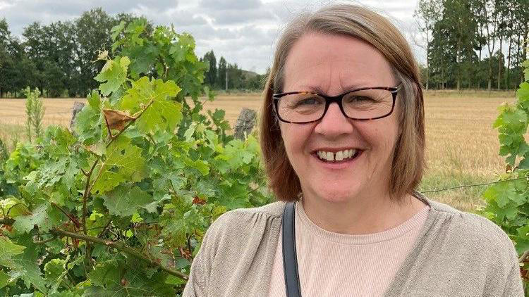 Woman smiling after completing NHS Diabetes Prevention Programme in vineyard