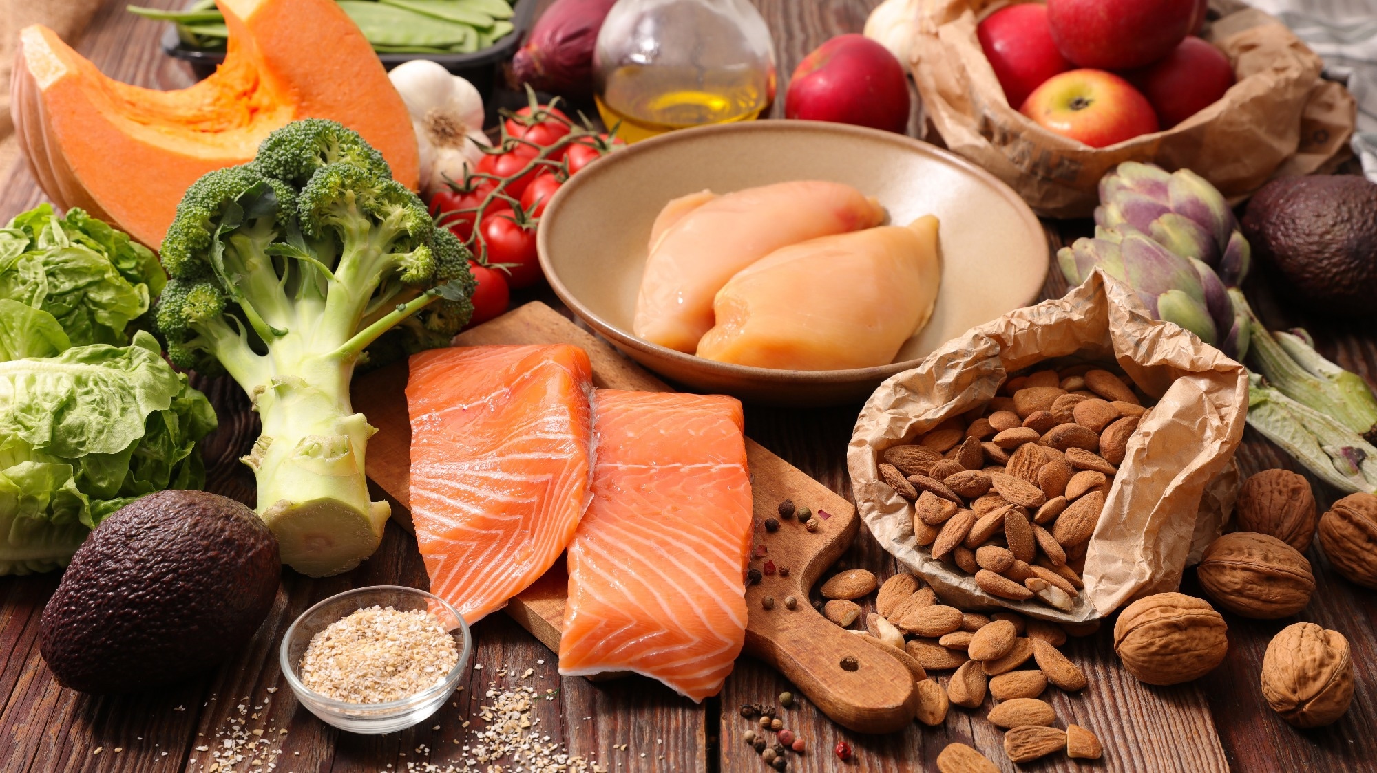 A diverse healthy diabetes friendly meal with plant proteins, fruits and vegetables on wooden table