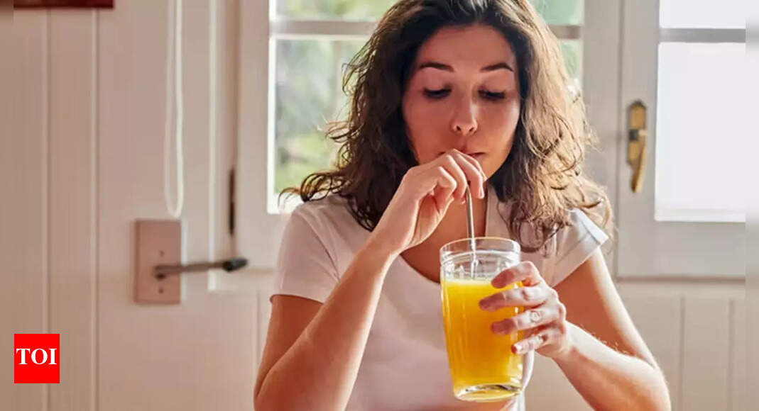 A woman sips orange juice, illustrating the negative impact of sugary beverages on diabetes risk for women