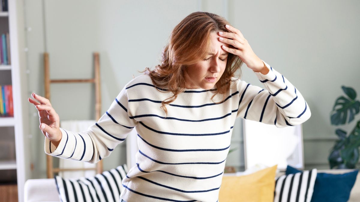 Woman experiencing low blood sugar symptoms and sweating