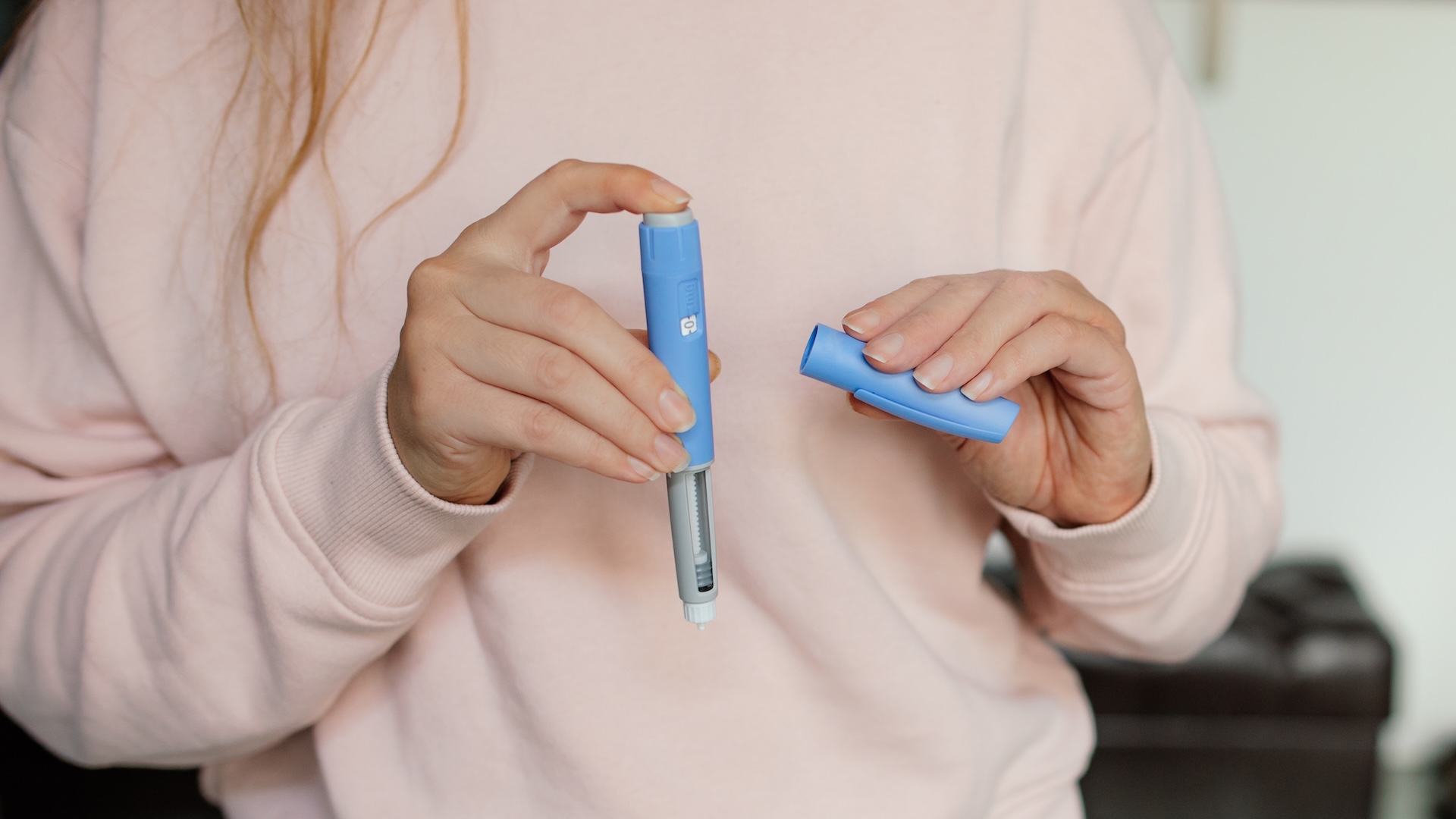 A person holding electronic devices, symbolizing the potential use of semaglutide-like drugs as treatment for type 1 diabetes alongside insulin